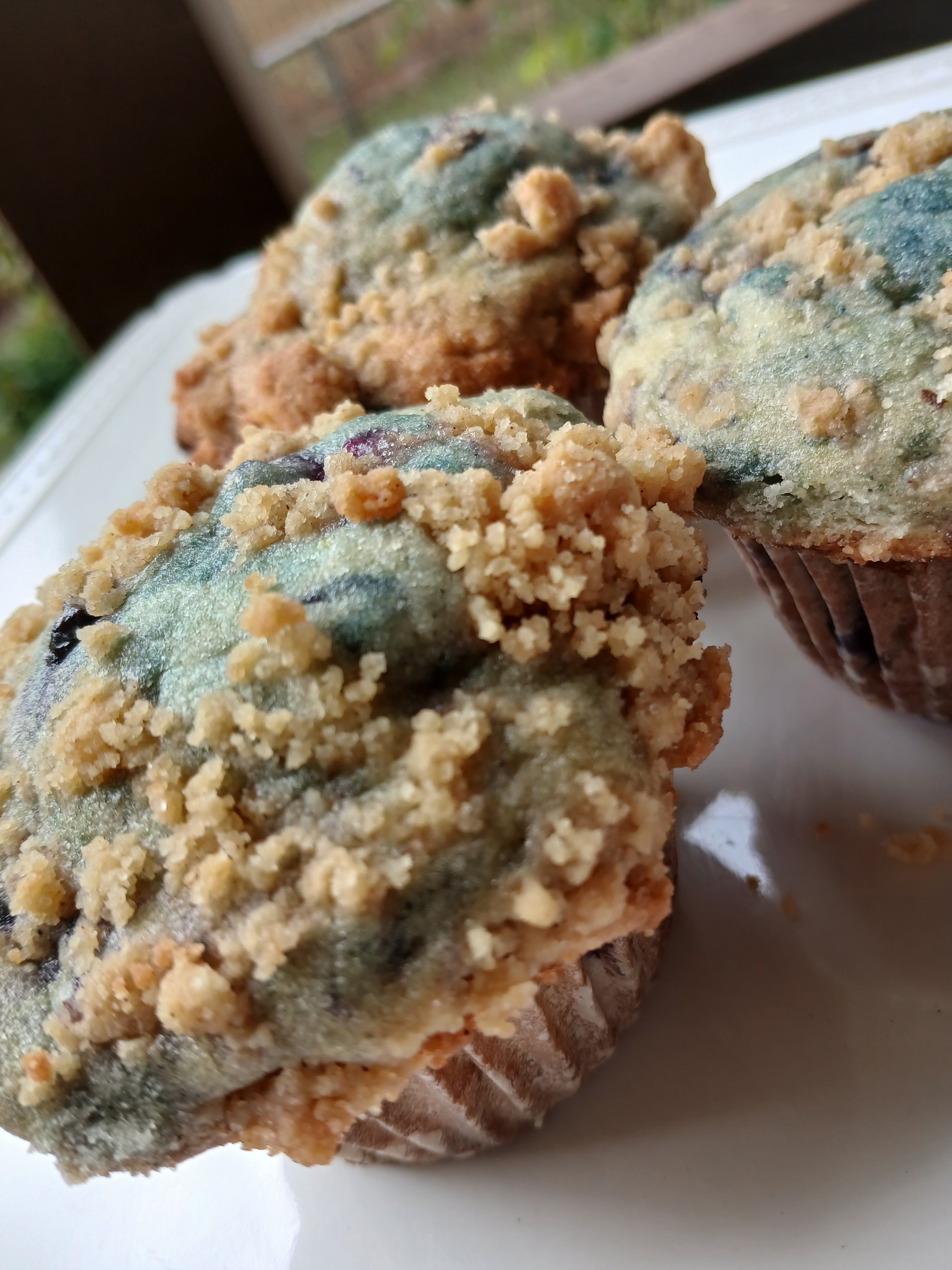 Muffins with a crumbly topping on a white plate